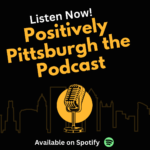 Cover art for "Positively Pittsburgh the Podcast," showcasing a microphone with the Pittsburgh skyline, text on the bottom says “Available on Spotify.”